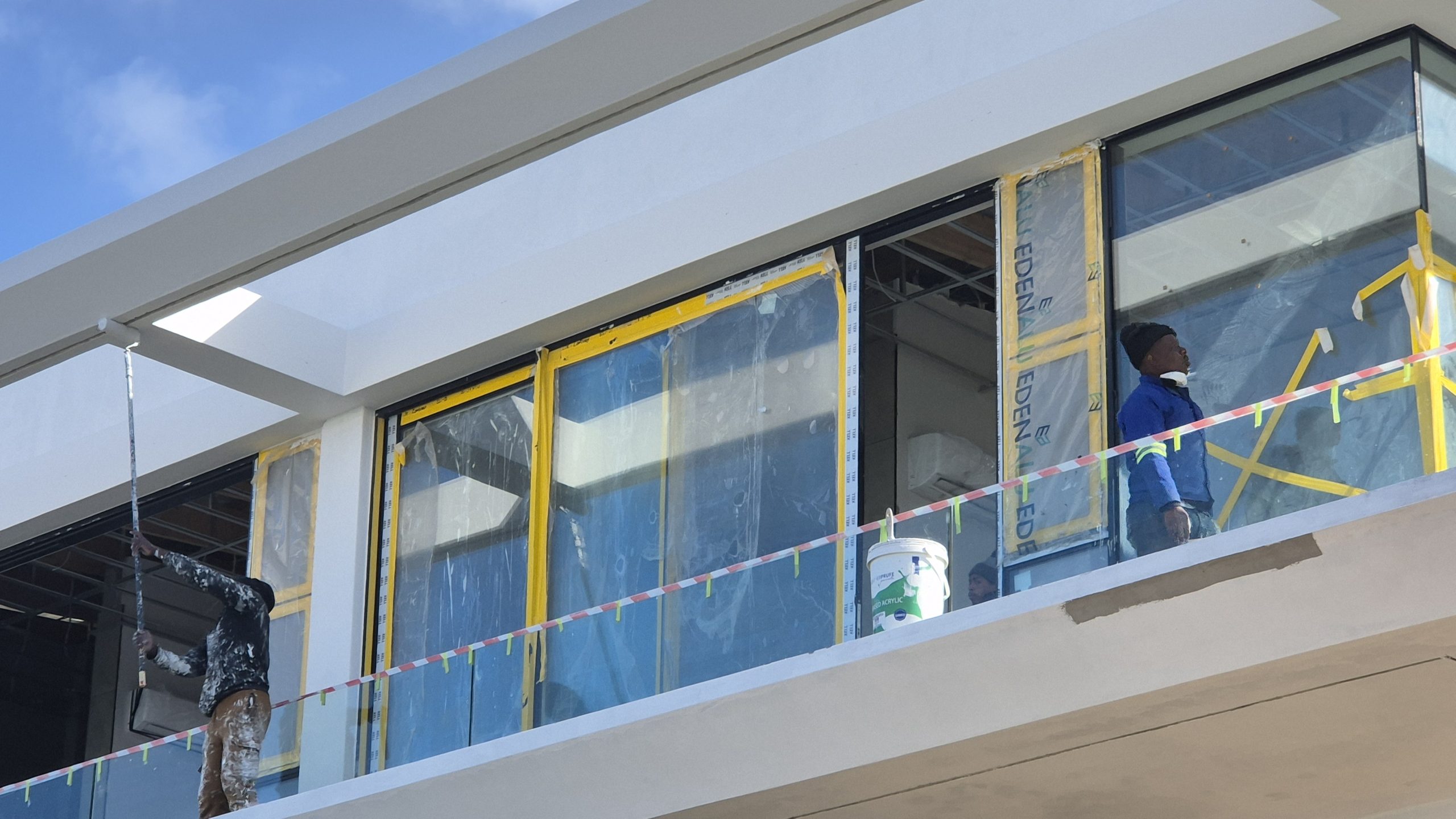 Painter applying waterproofing paint in West Coast to prevent water ingress and surface damage, supplied by WeatherPrufe Paint Shop.