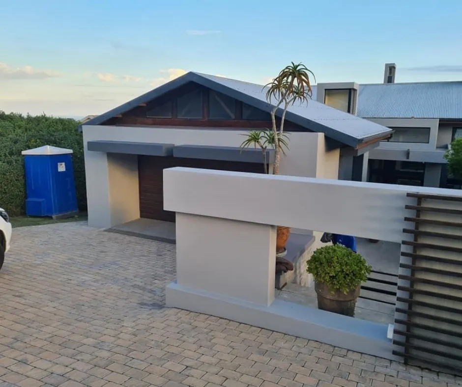 Damp stained wall being repaired and sealed with waterproof paint in a Cape Town home.