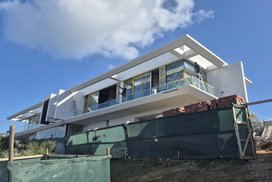 Front view of a West Coast coastal home protected with flexible waterproofing paint from WeatherPrufe Paint Shop West Coast, sealing walls against cracks and rain.
