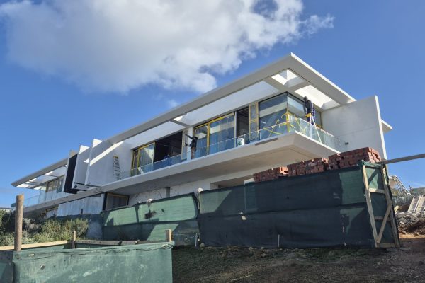 Front view of a West Coast coastal home protected with flexible waterproofing paint from WeatherPrufe Paint Shop West Coast, sealing walls against cracks and rain.