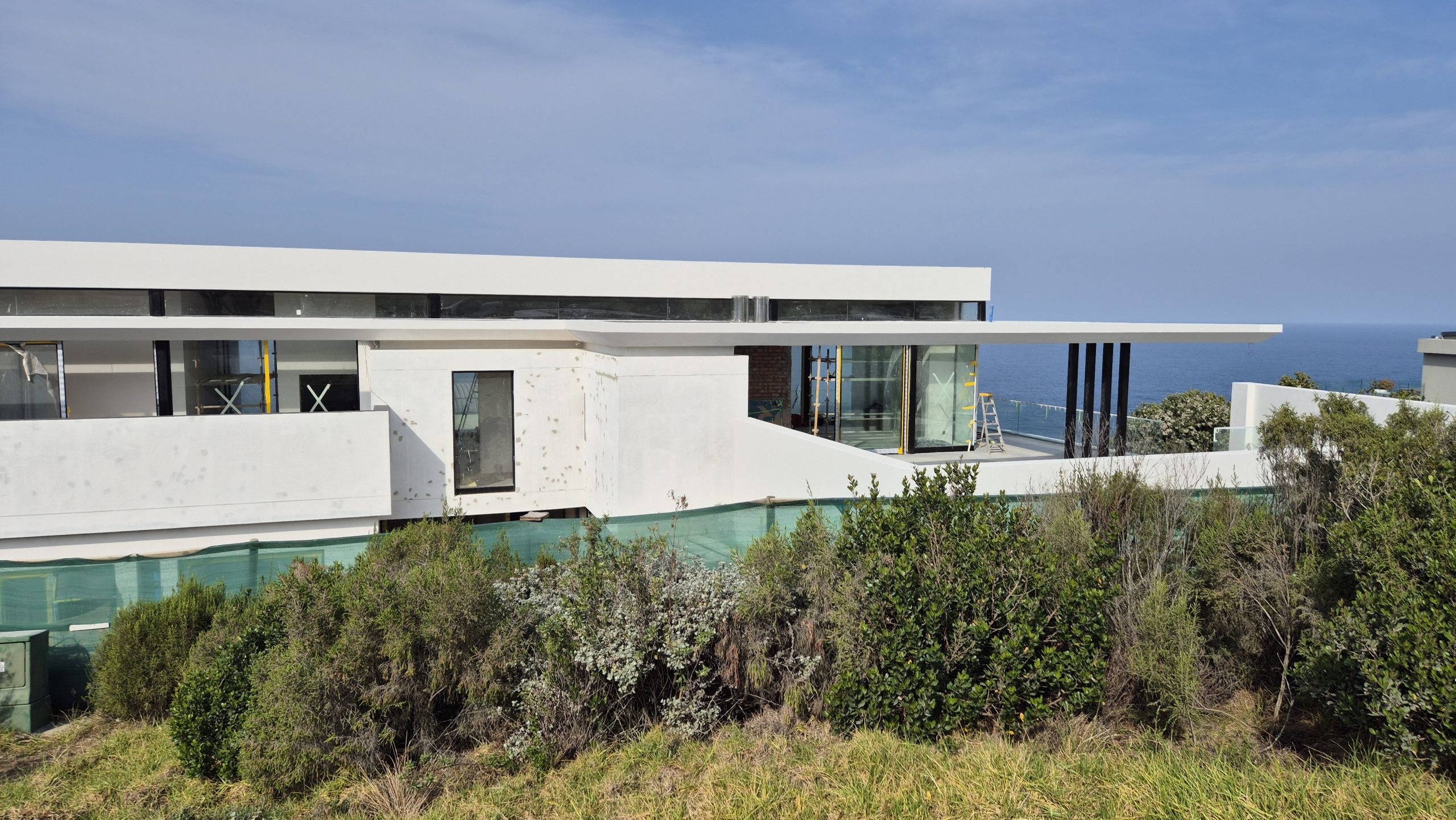 Side-by-side comparison of regular paint versus waterproof paint in Western Cape weather.