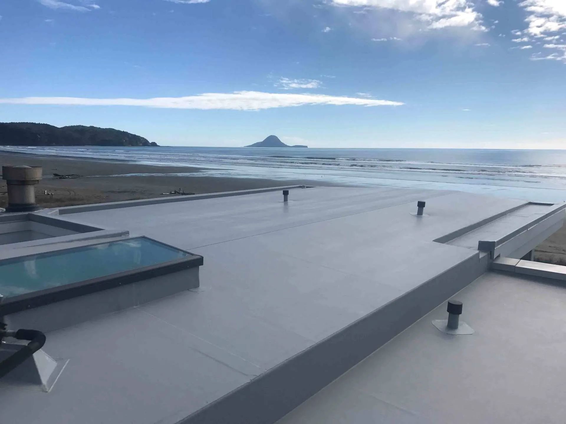 A Cape Town roofer applying UV-stable waterproofing paint supplied by WeatherPrufe Paints.
