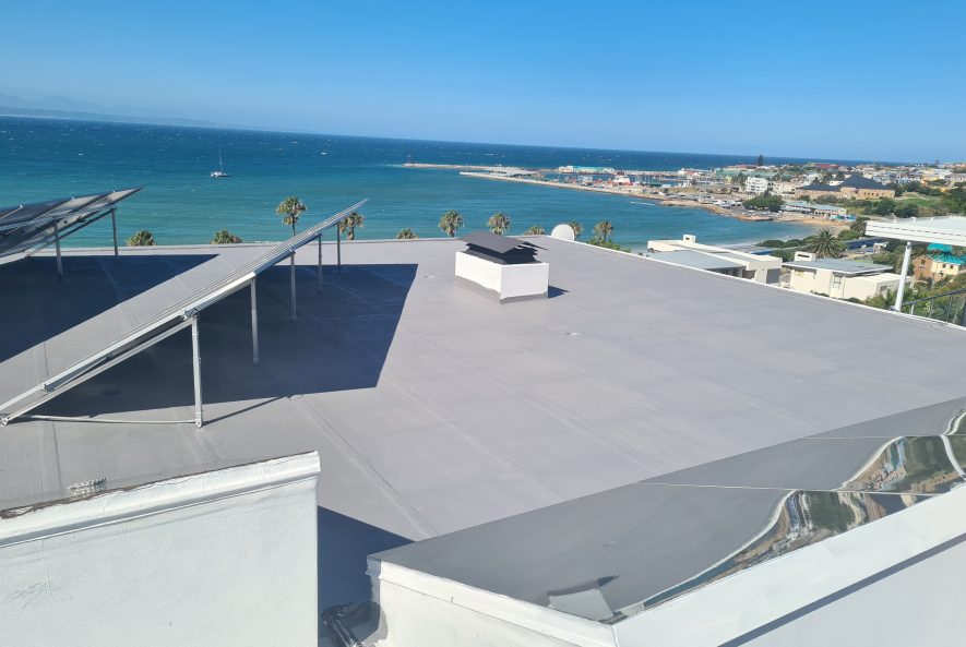 Damaged torch-on roof surface at Mossel Bay before WeatherPrufe Elastocryl repair.