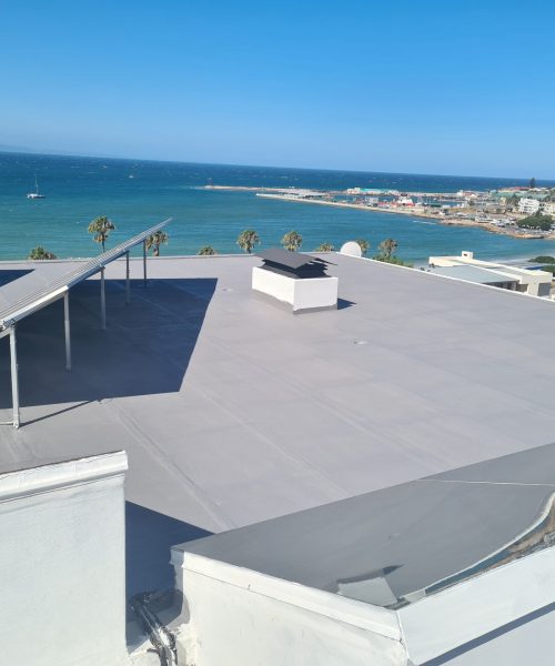 Damaged torch-on roof surface at Mossel Bay before WeatherPrufe Elastocryl repair.