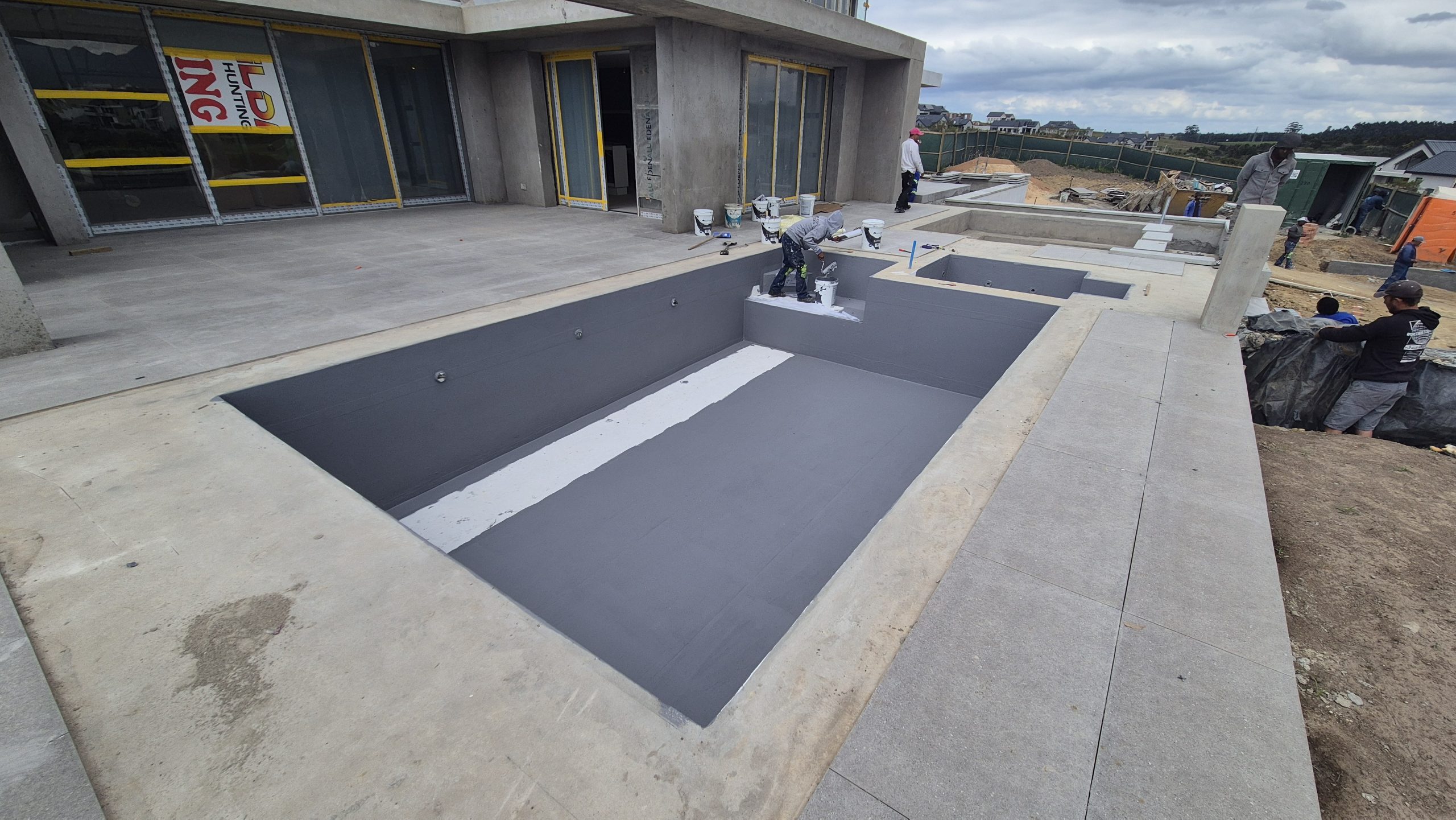 DJ Waterproofing & Paint Services preparing pool and jacuzzi surfaces before WeatherPrufe system application.