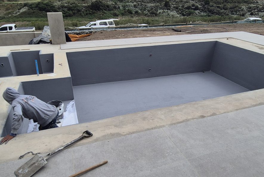Weatherbond Enhance mixed with cement used to improve tile adhesion on waterproofed pool surfaces.