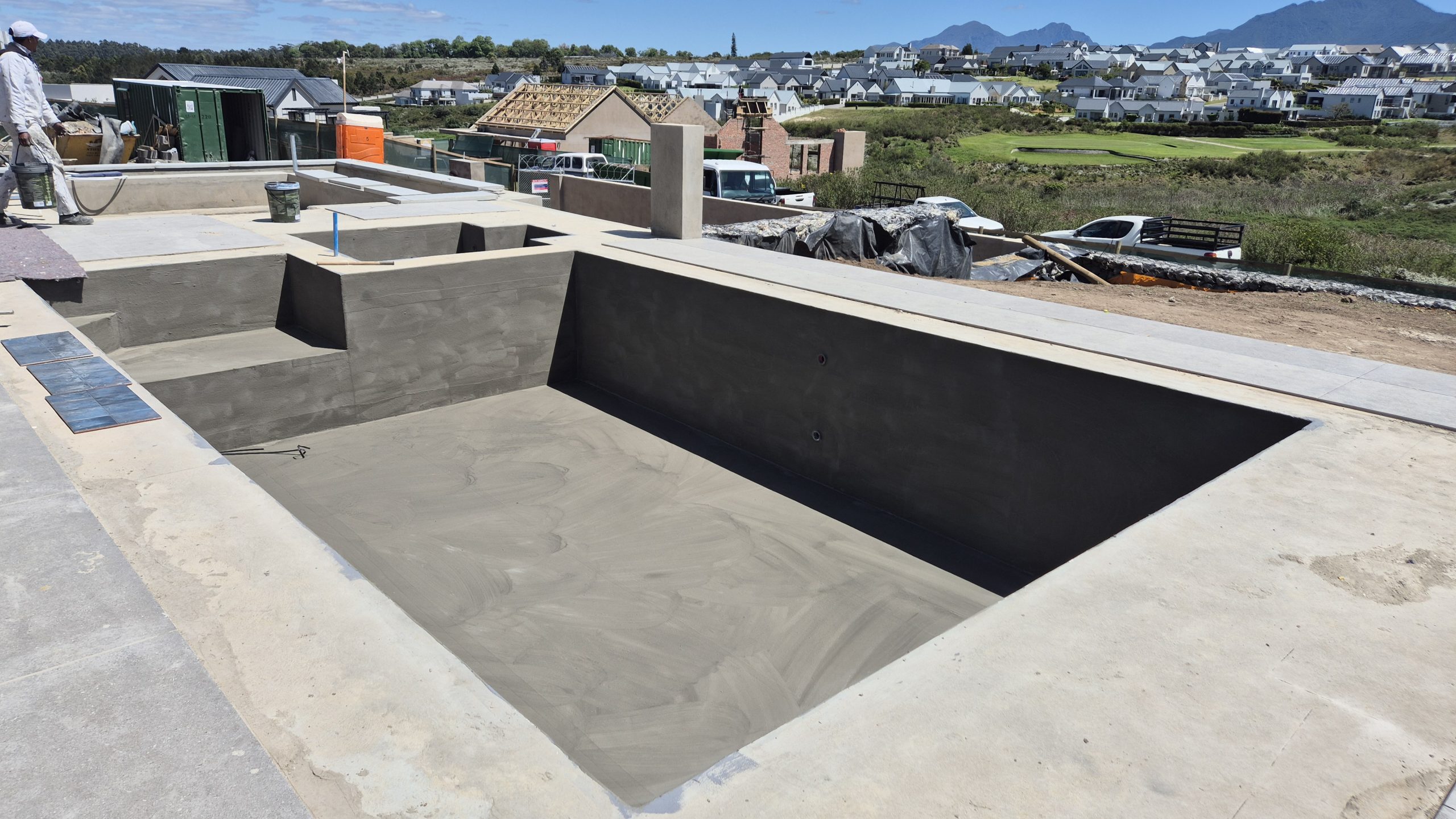 Waterproofing team applying WeatherPrufe Elastocryl coating inside swimming pool at Kingswood Estate in George.