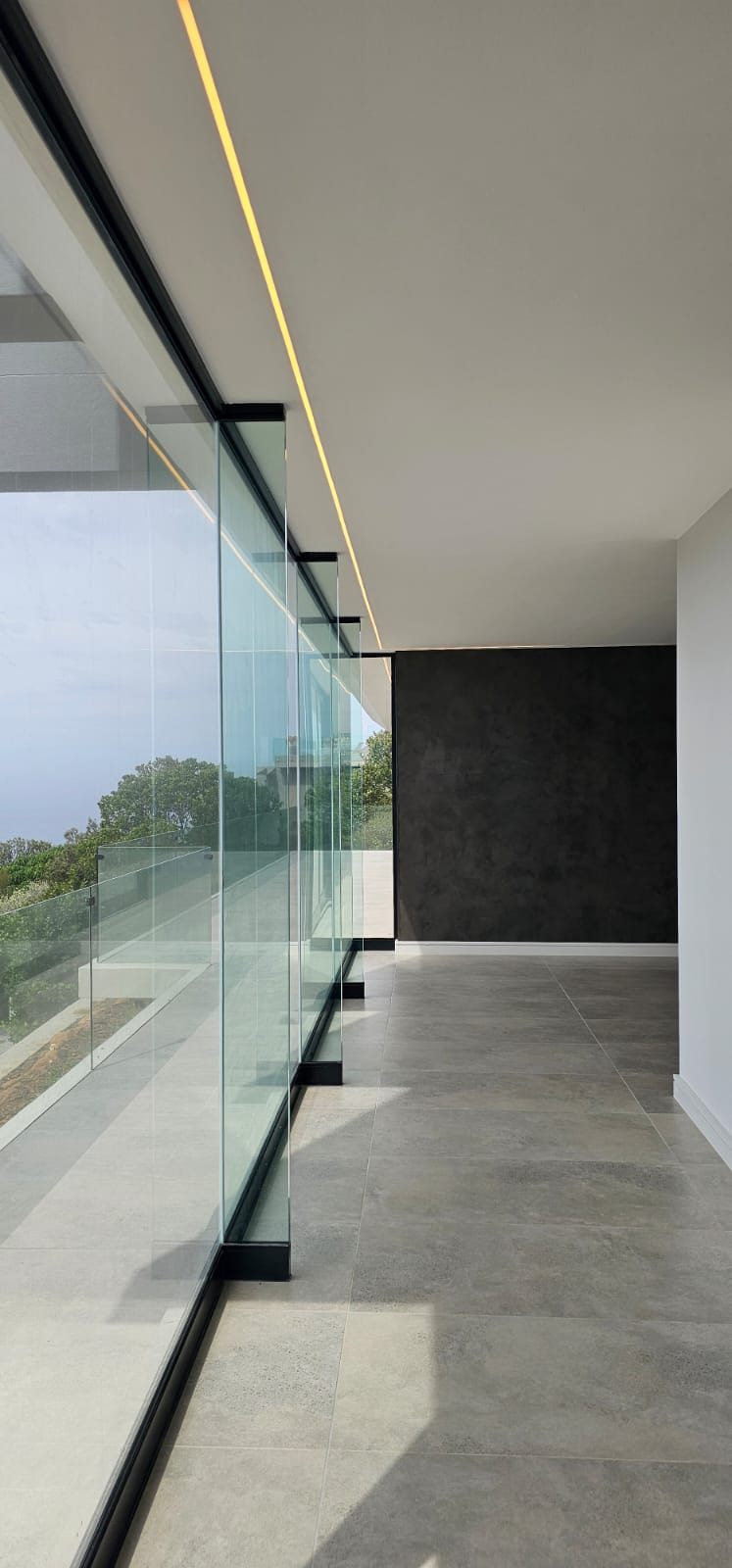 Final acrylic coat applied inside lounge area, producing refined coverage and consistent colour tone throughout interior spaces.