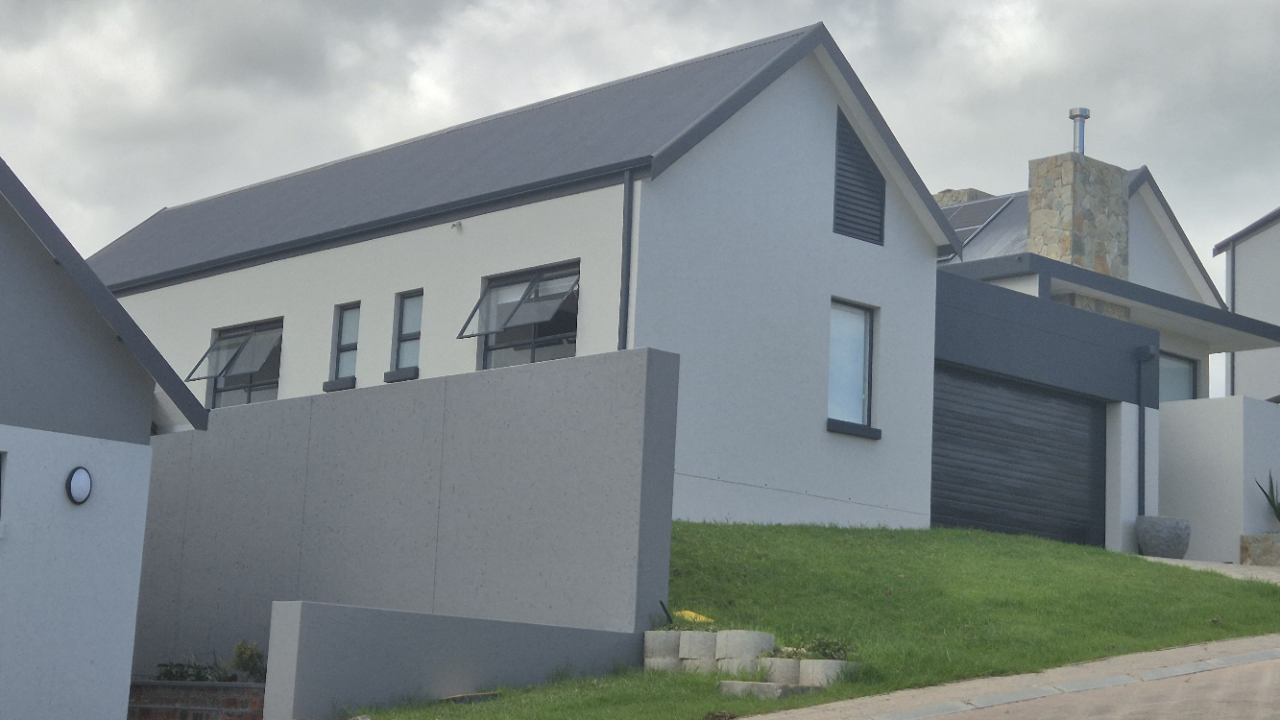 Elastocryl membrane applied along roof perimeter sealing vulnerable joins against coastal rain exposure in Mossel Bay